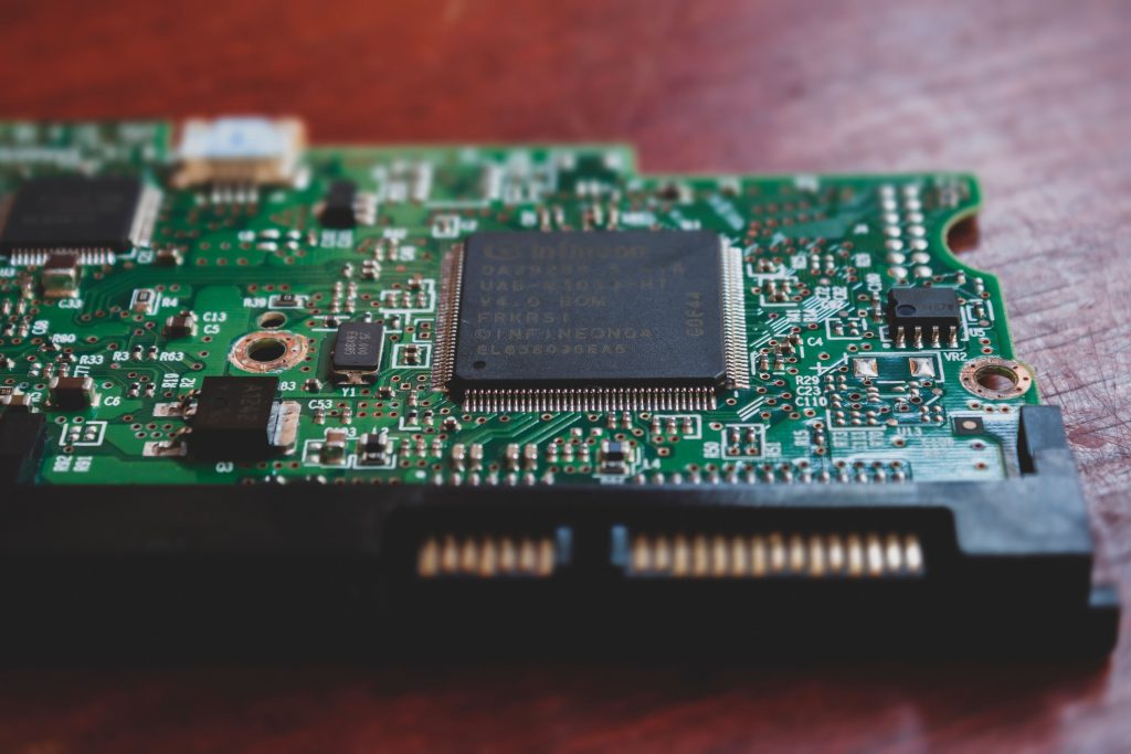Detailed close-up of a green electronic circuit board, highlighting technology components. 